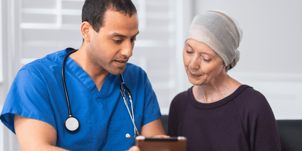 Older adult female with illness learning from male nurse