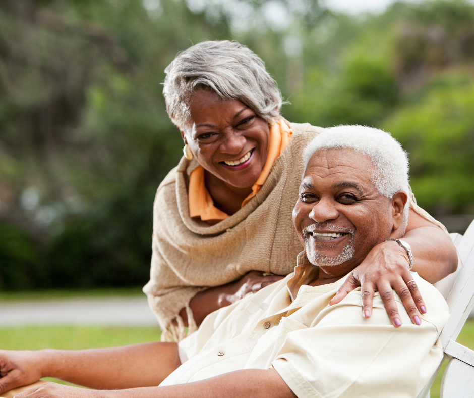 African American senior couple sitting outside